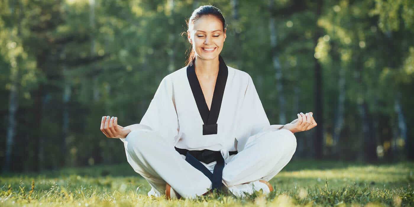 Martial Arts Lessons for Adults in Columbia MO - Happy Woman Meditated Sitting Background